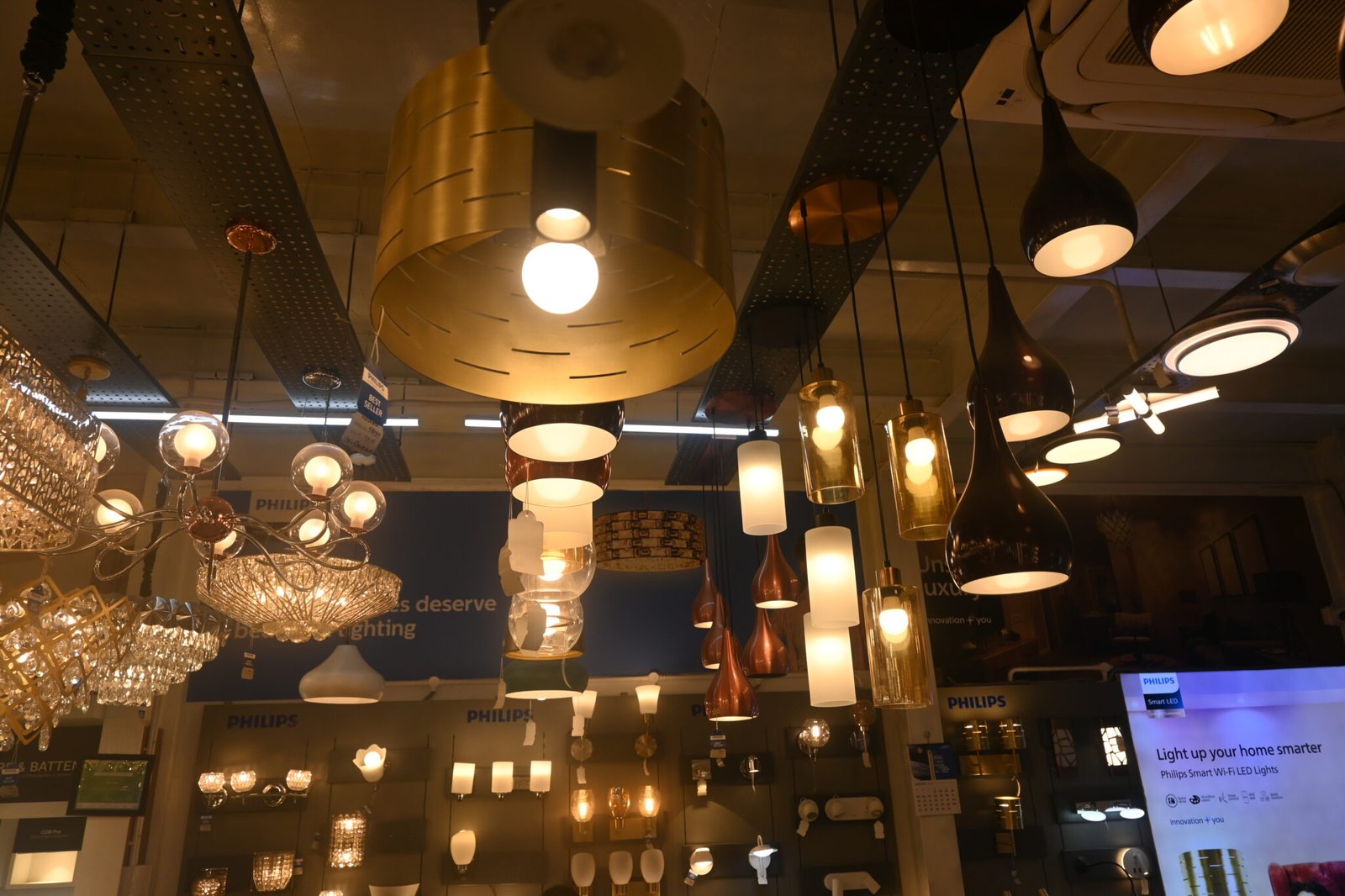 Luxury golden chandelier display at Elite Hues Katupakkam showroom